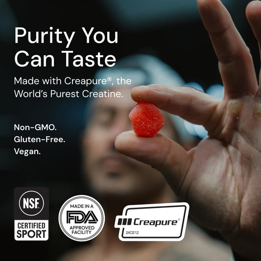Gummies spilling from bottle showing red sour cherry color
