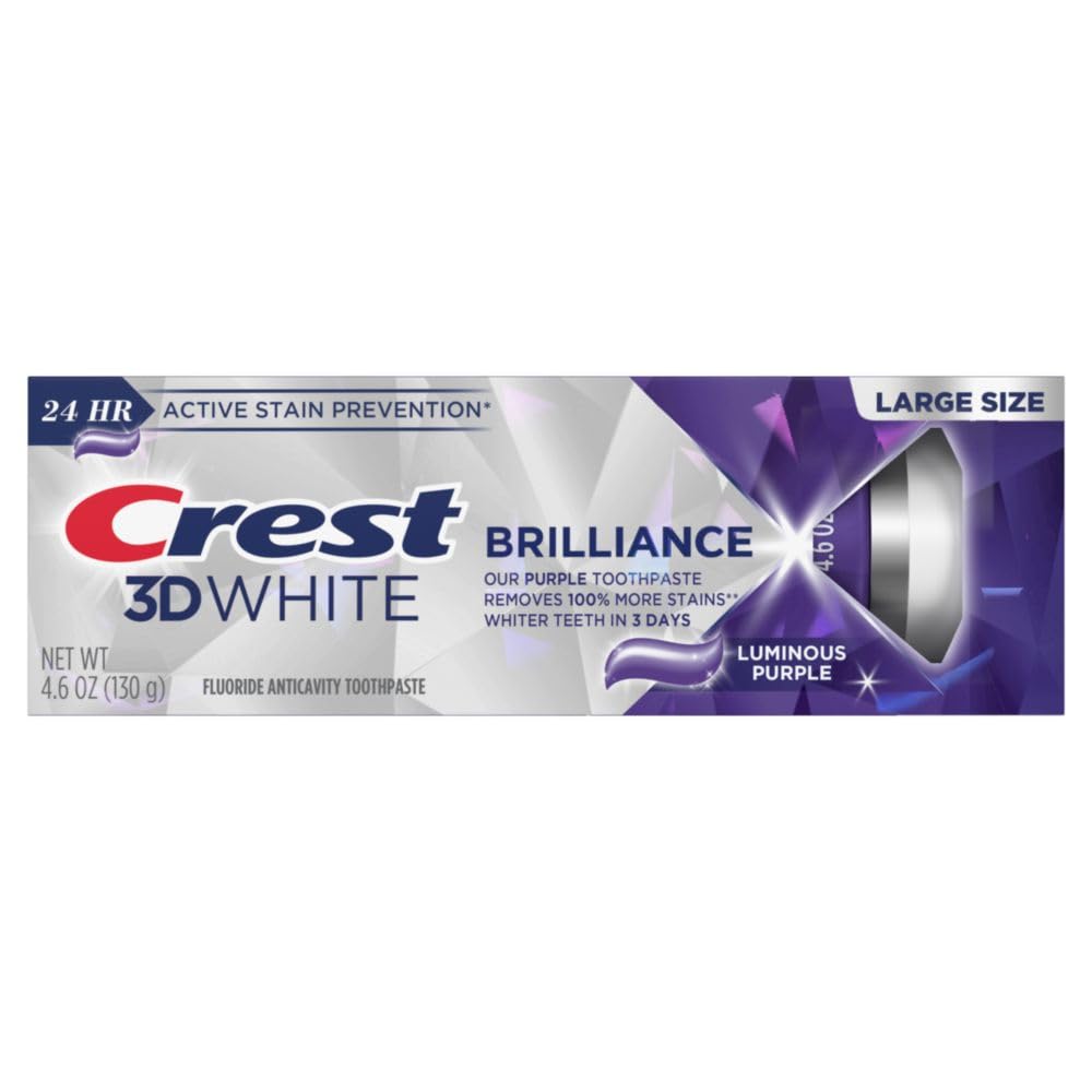 Toothbrush applying Crest 3D White Brilliance toothpaste to teeth