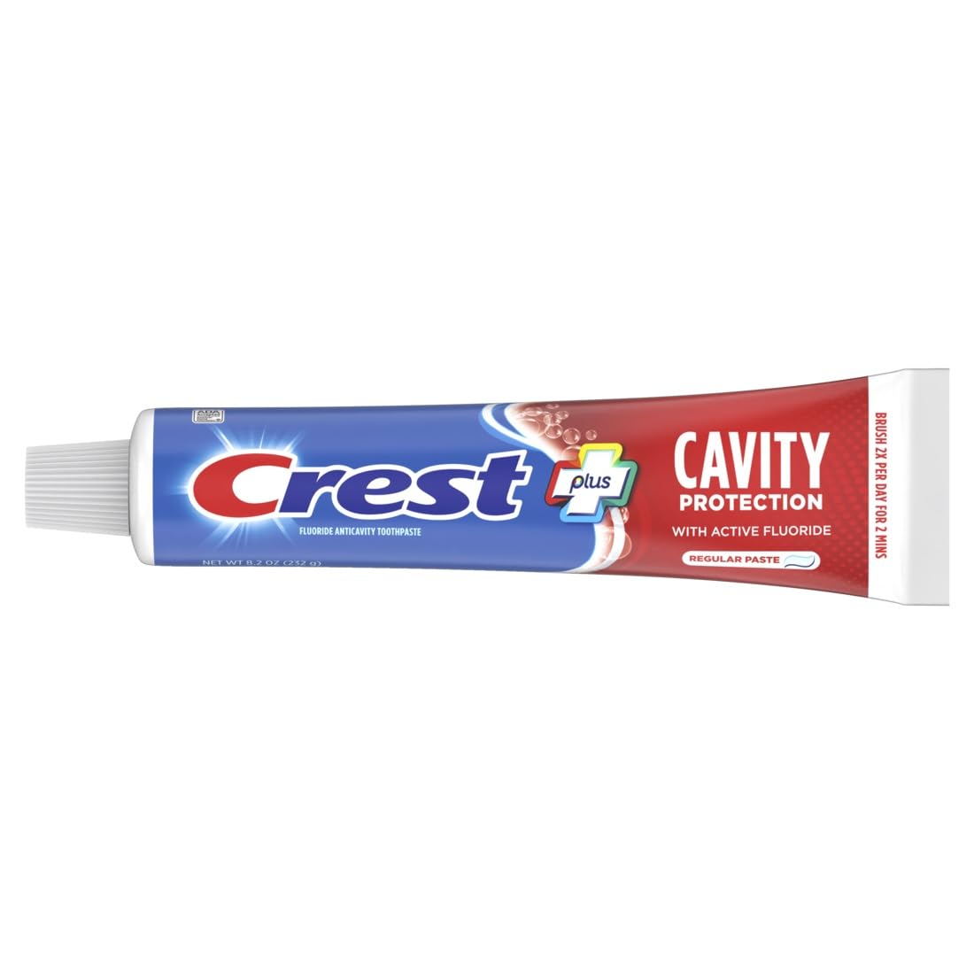 Close-up of toothpaste being dispensed onto a toothbrush.