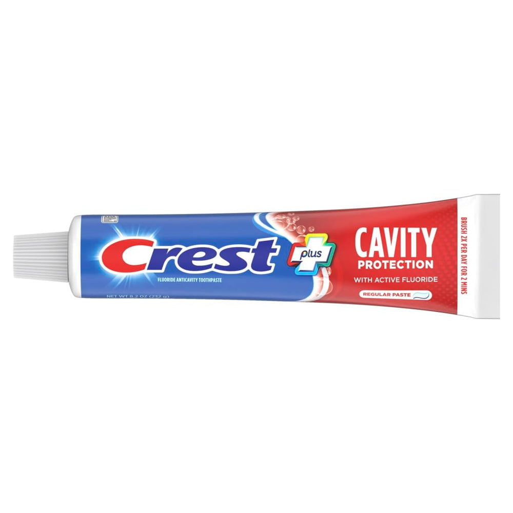 Close-up of toothpaste being dispensed onto a toothbrush.