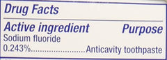 Graphic on toothpaste tube highlighting whitening and tartar-fighting action