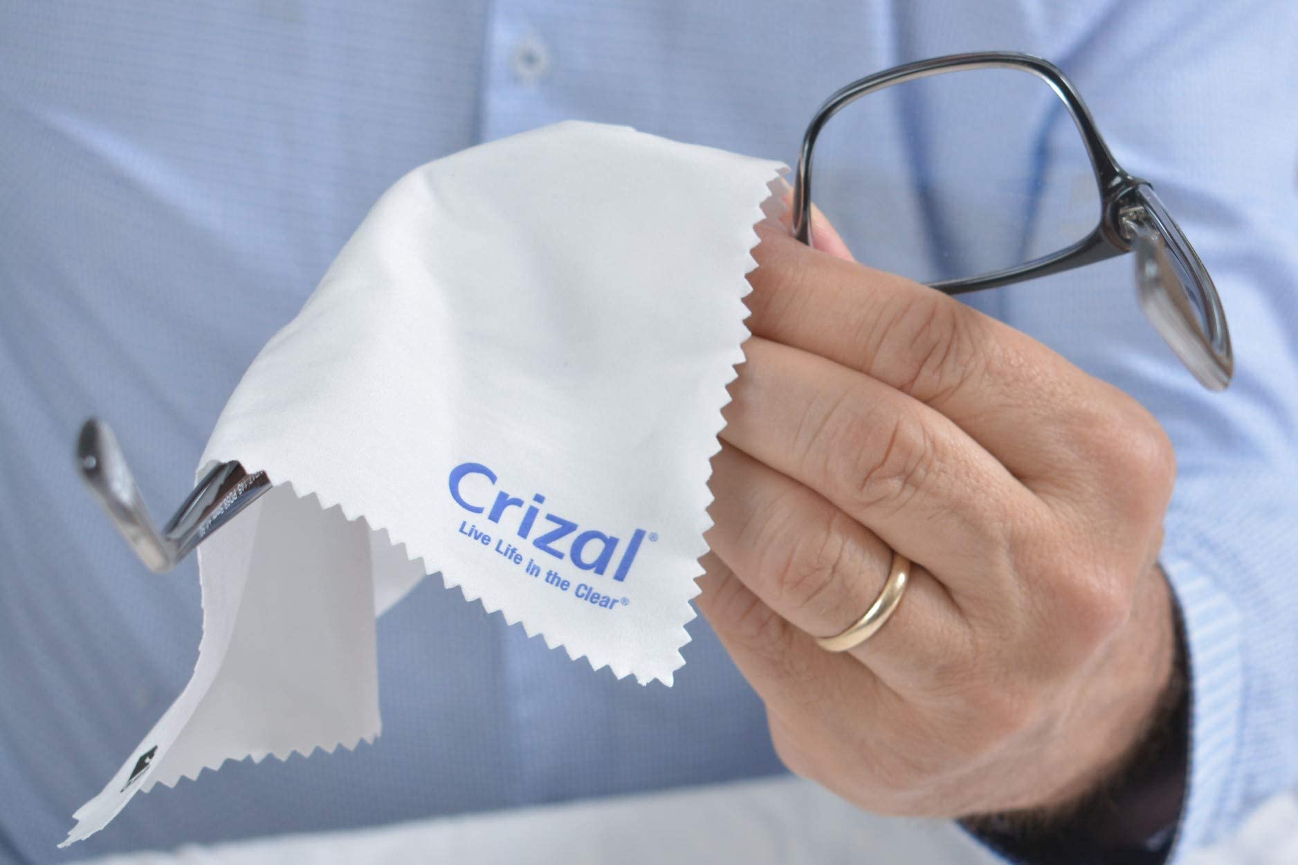 Glasses being cleaned with Crizal microfiber cloth on AR-coated lenses