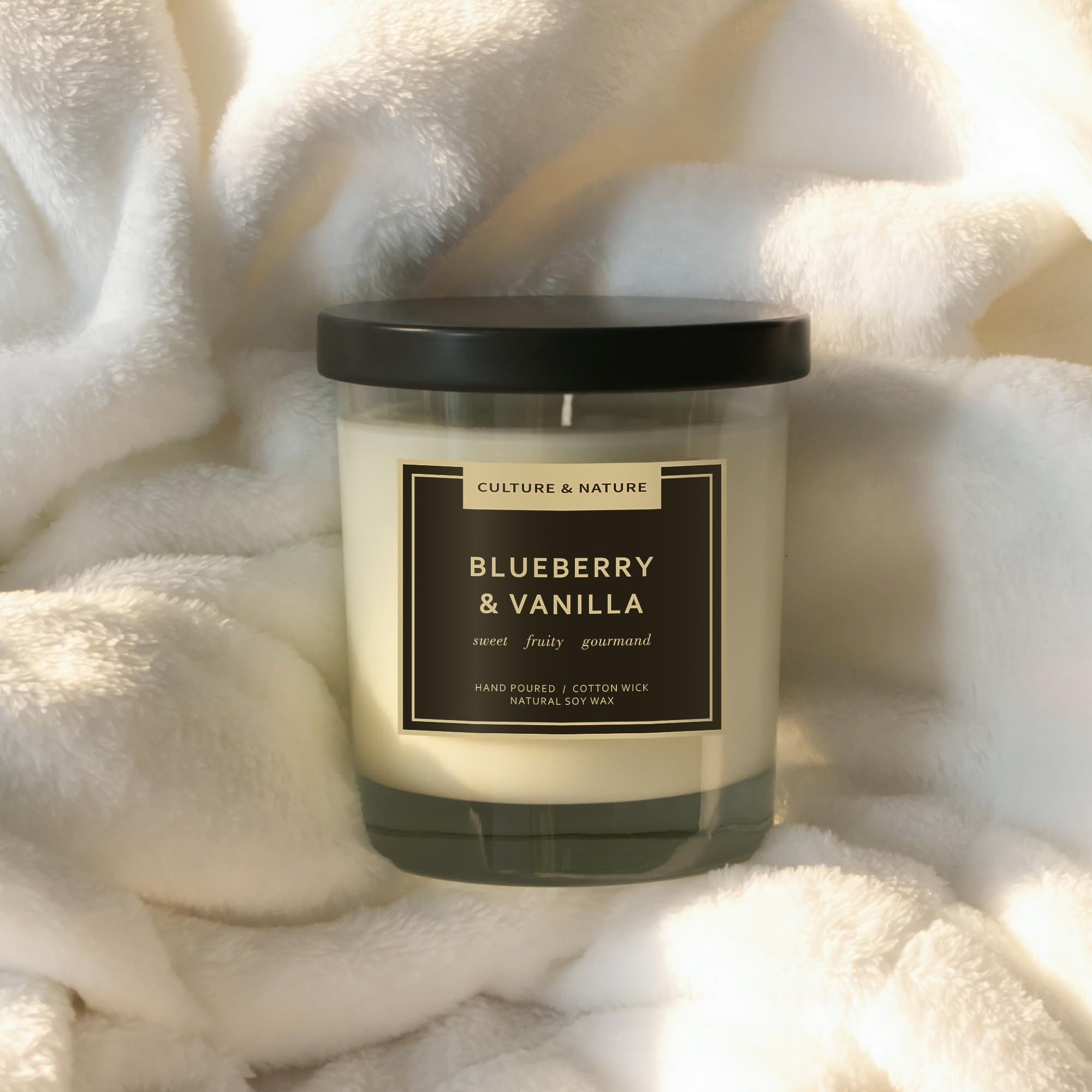 Lifestyle shot of CULTURE & NATURE 7oz Soy Wax Candle in Blueberry & Vanilla in home setting