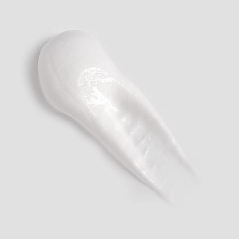 Toothpaste being applied to a toothbrush for Curaprox Enzycal