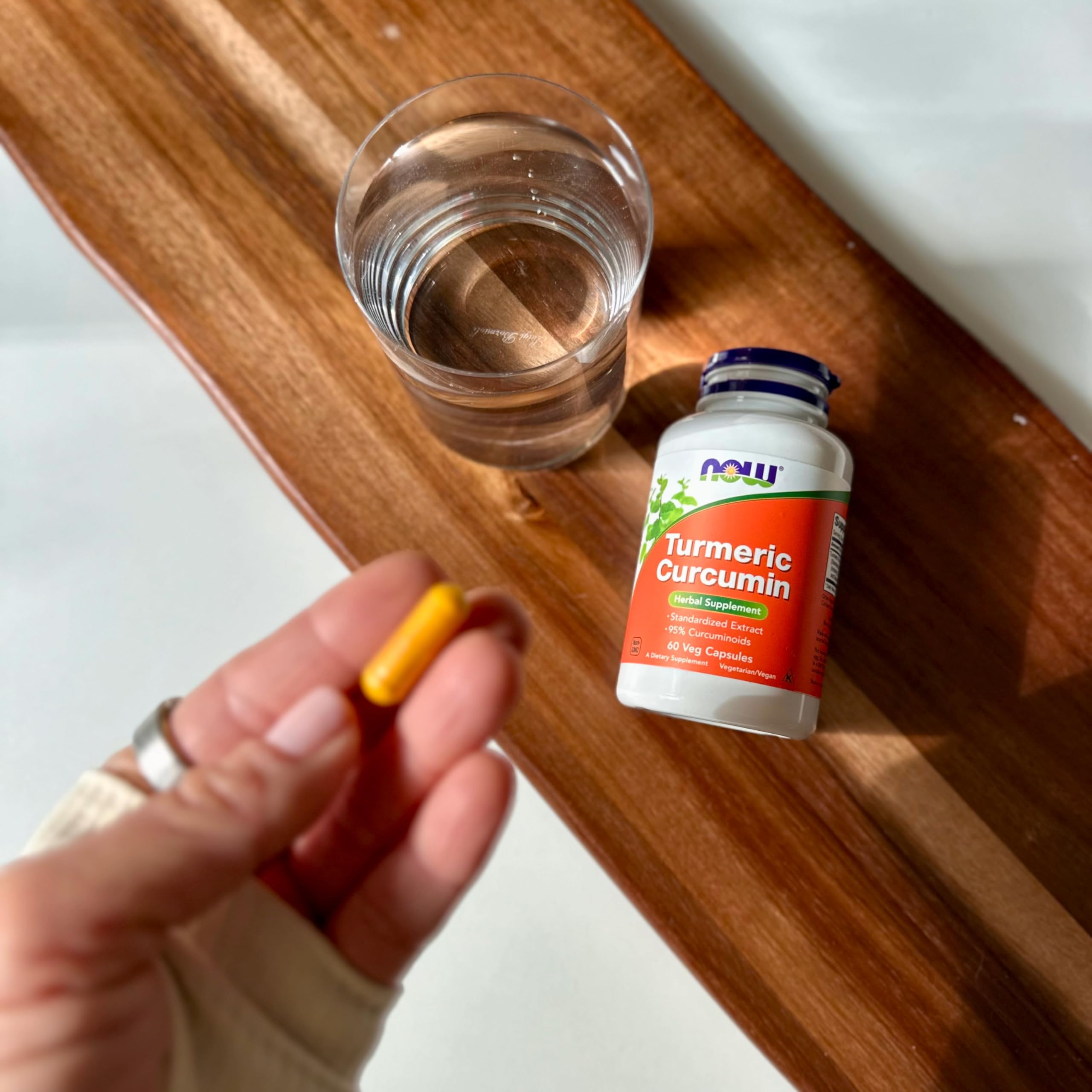 Capsules and turmeric curcumin bottle close-up