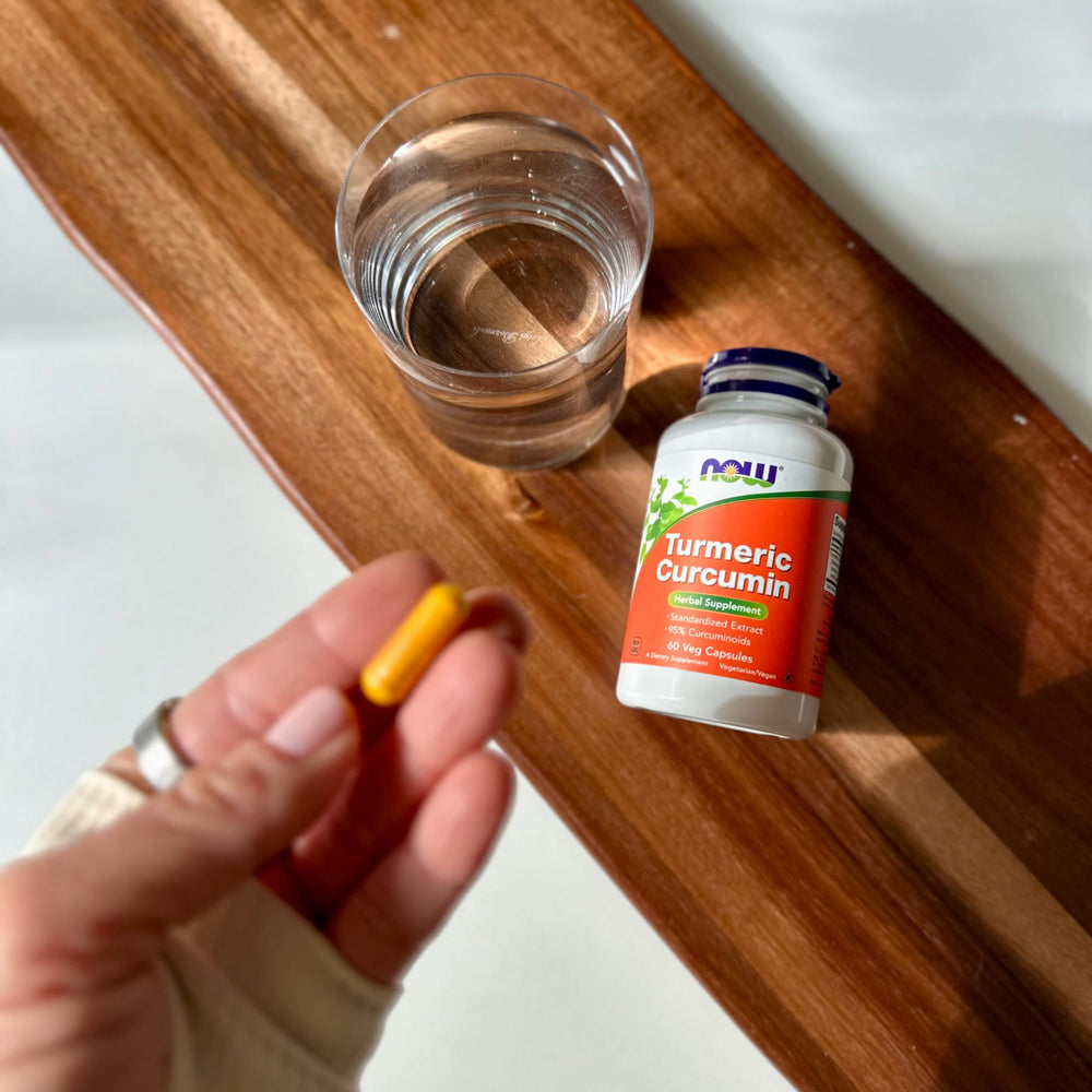 Capsules and turmeric curcumin bottle close-up