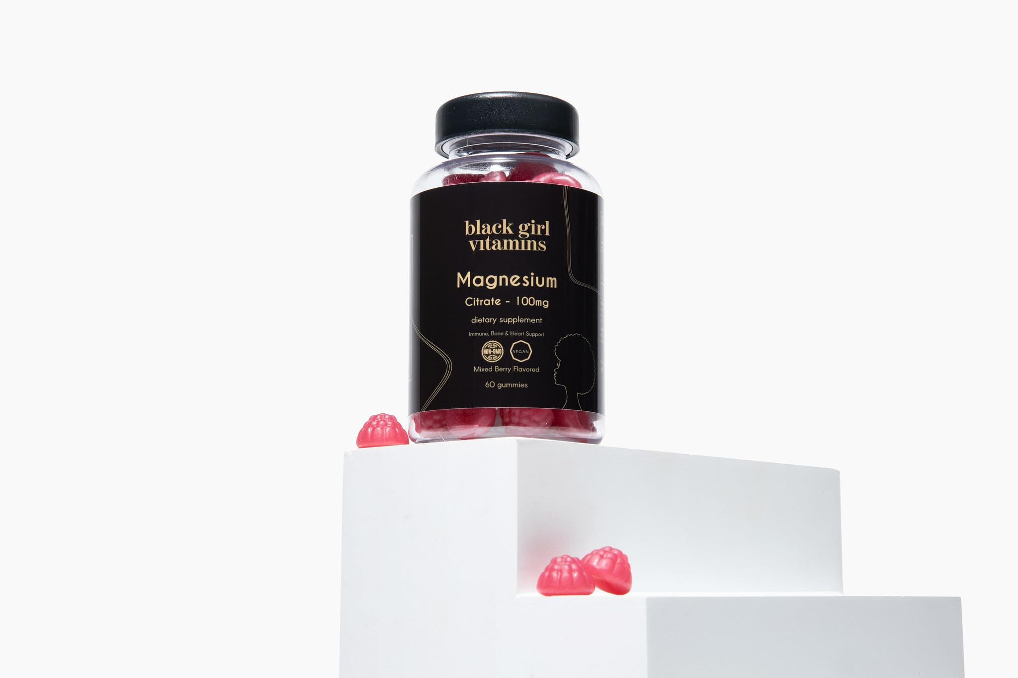 One daily magnesium gummy on a clean surface with a glass of water