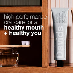 Squeezing Davids Charcoal Toothpaste from recyclable metal tube with squeezer