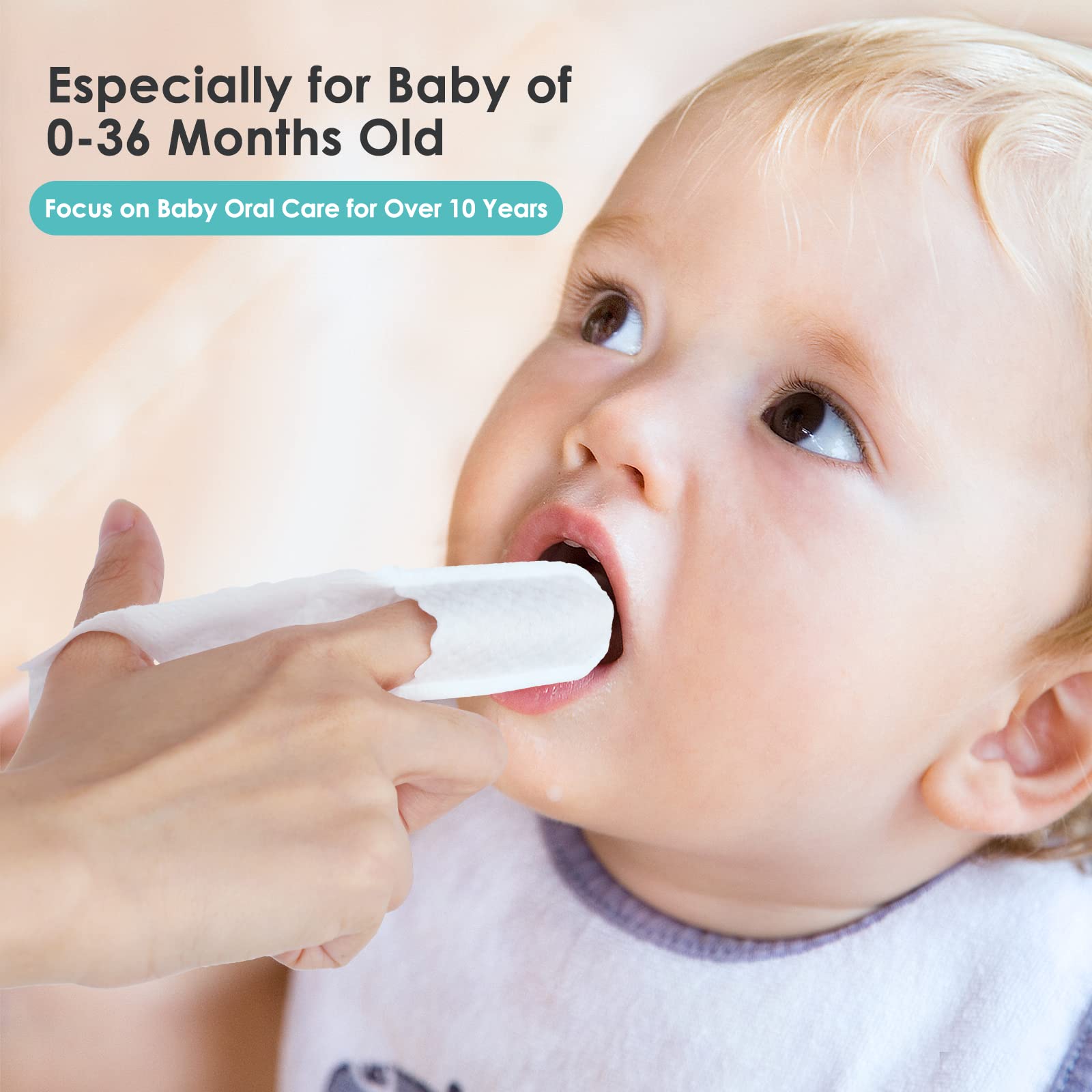 Baby teething gums being massaged with tongue cleaner