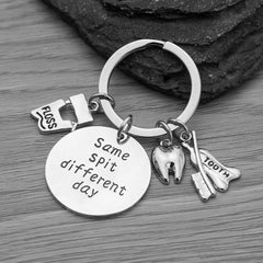 Silver-plated dental keychain close-up with same spit different day charm
