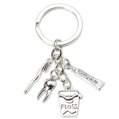 Silver dental keychain with toothbrush and floss pendant
