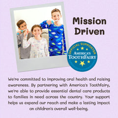Happy toddler using a dinosaur toothbrush designed for ages 2 and up