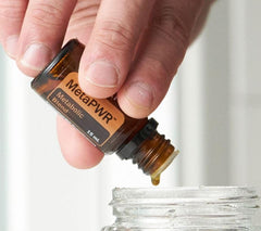 Close-up of doTERRA MetaPWR Metabolic Blend bottle with dropper