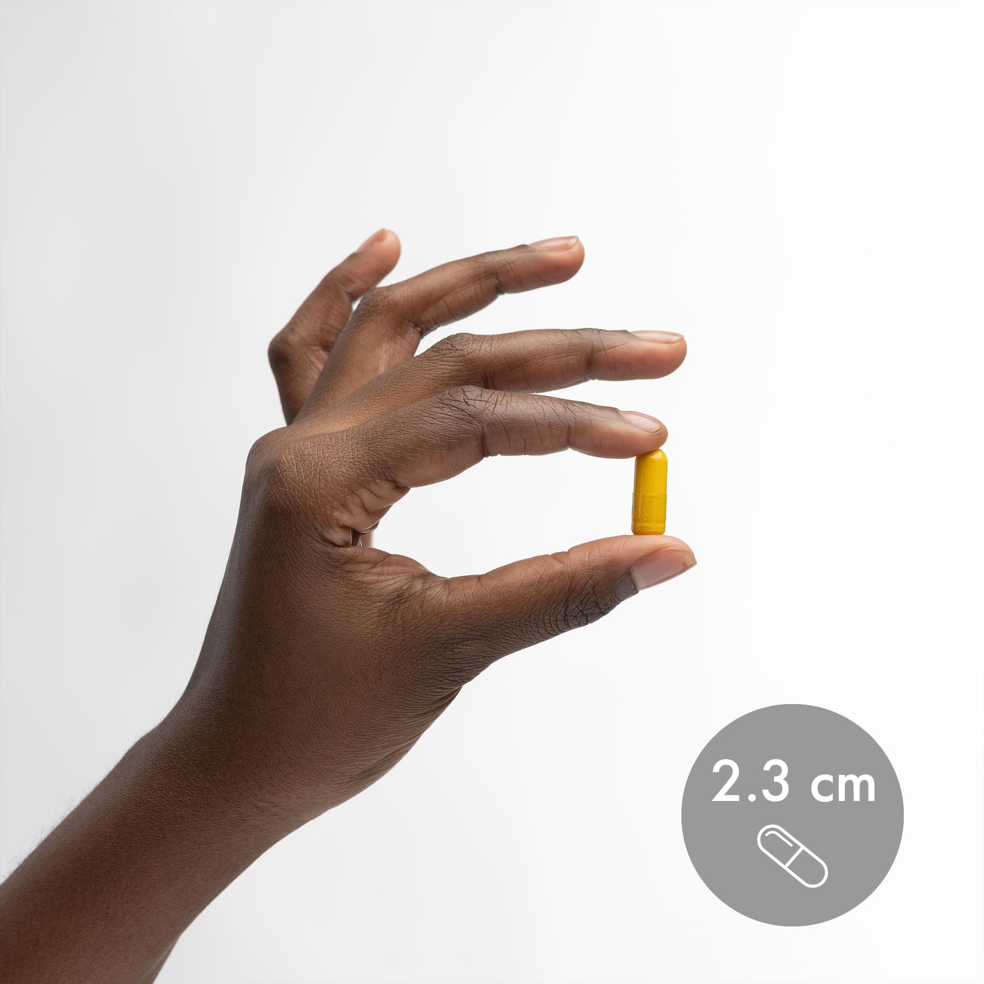 Turmeric roots with capsules representing high curcuminoid content