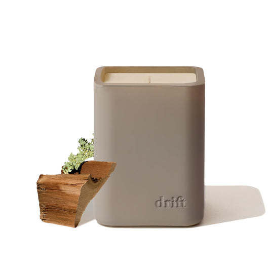 Drift Teak scented candle showing sleek modern glass jar
