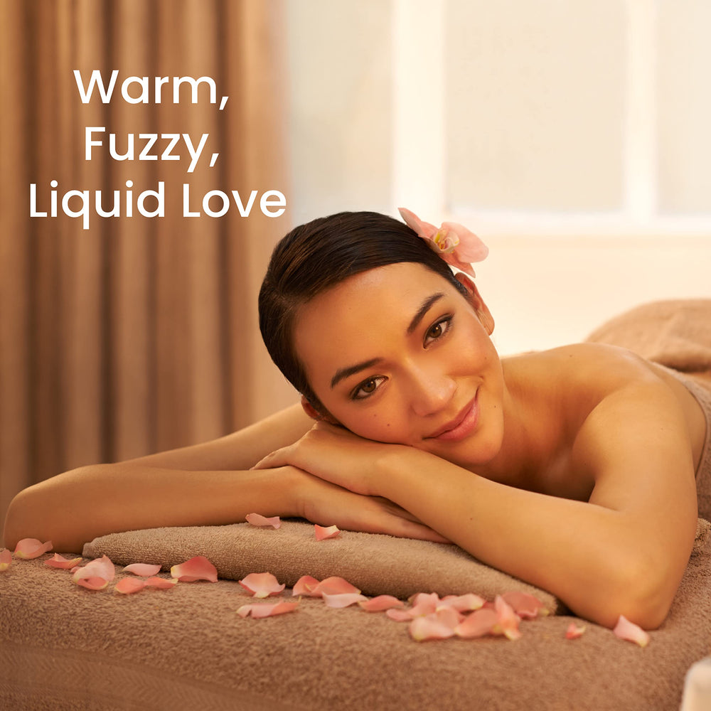 Pouring Apple Cinnamon warming massage oil into hands