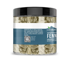 Close-up of fennel seed capsules next to bottle