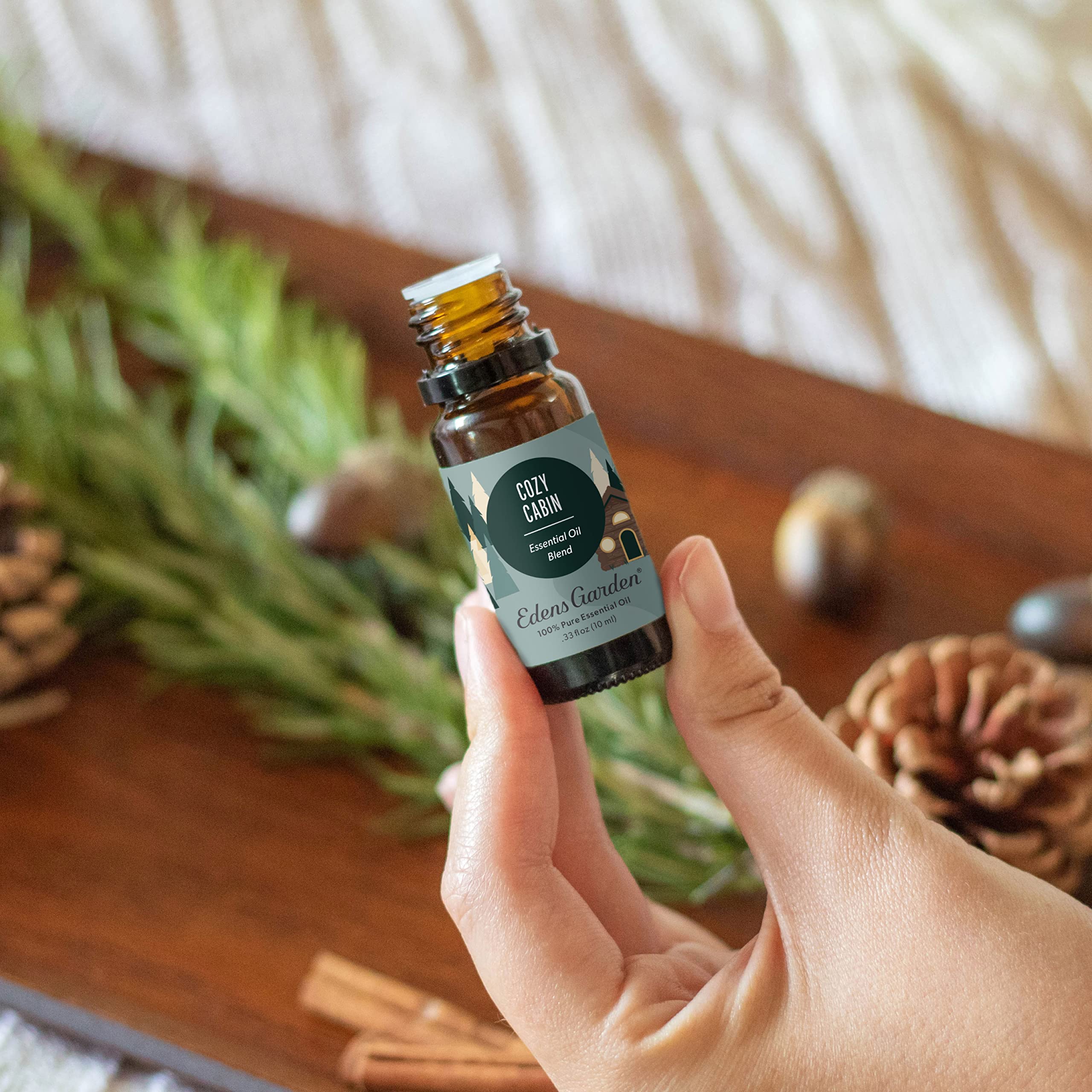 Close-up of Cozy Cabin essential oil bottle with dropper