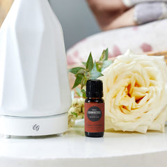 Close-up of Frankincense Sacra essential oil bottle with dropper