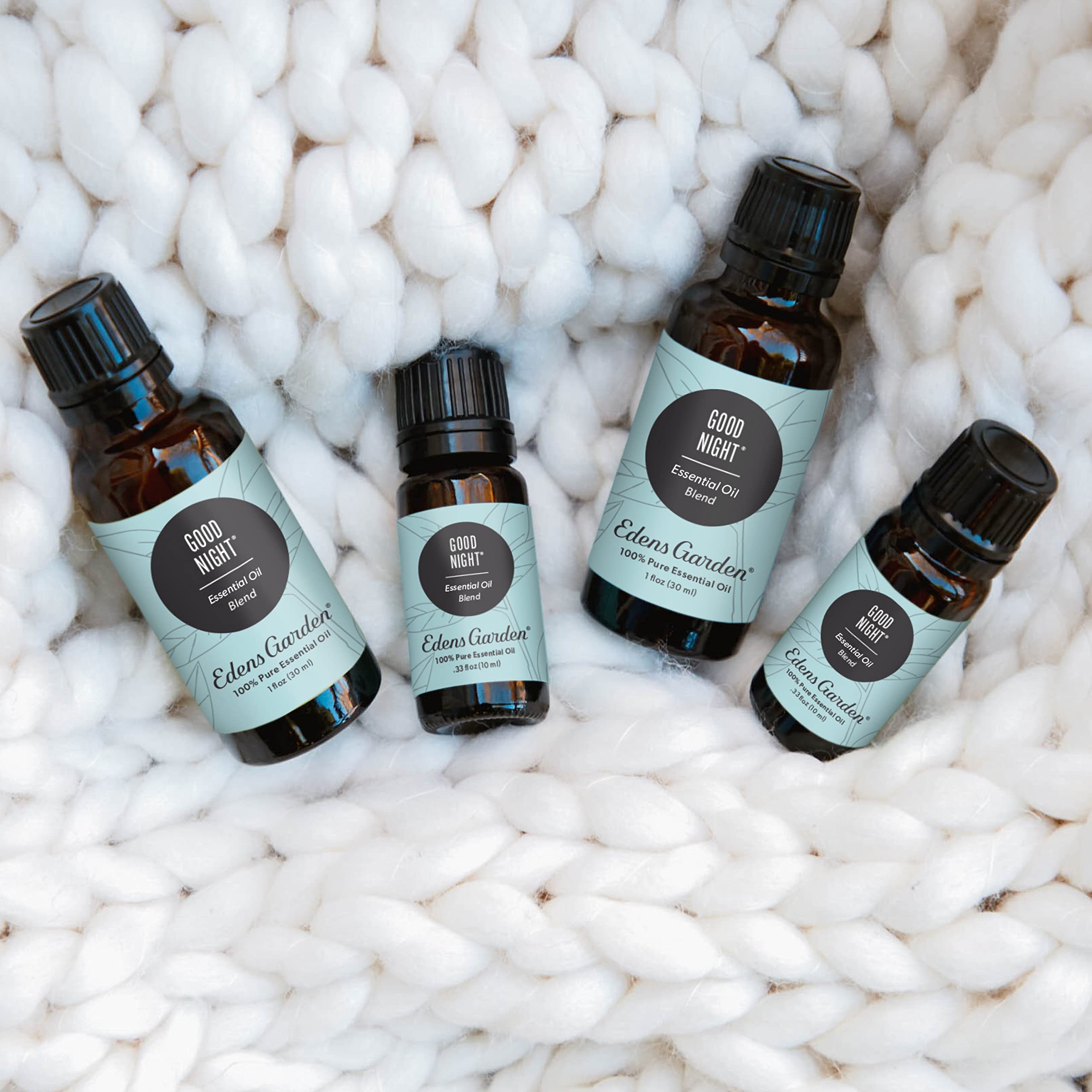 Dropper releasing oil from Good Night blend with soft focus