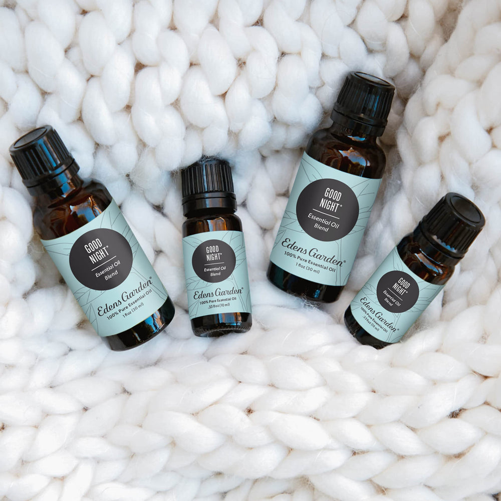Dropper releasing oil from Good Night blend with soft focus