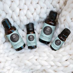 Dropper releasing oil from Good Night blend with soft focus