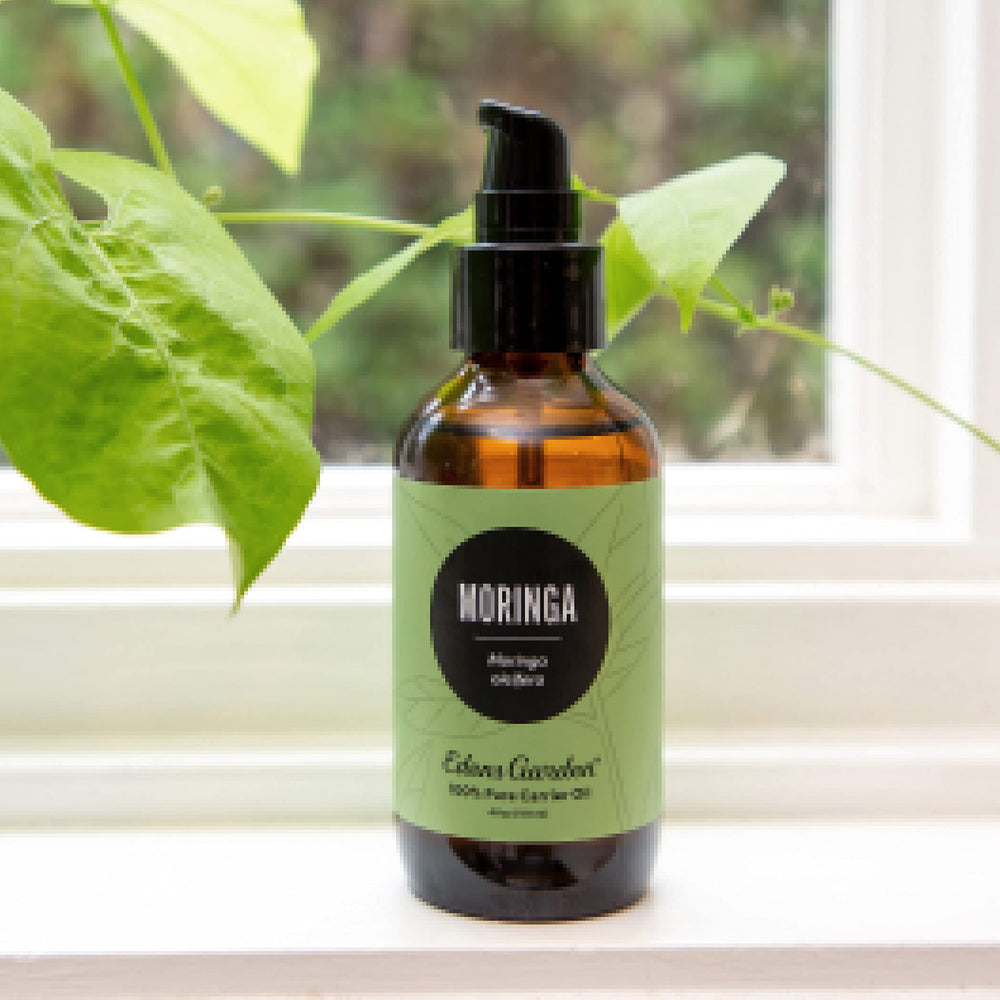 Pouring Moringa carrier oil from the bottle