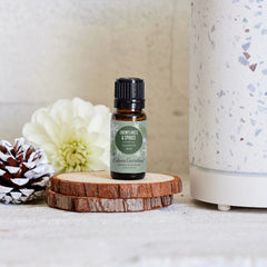 Close-up of Snowflakes & Spruce bottle with spruces and pine imagery