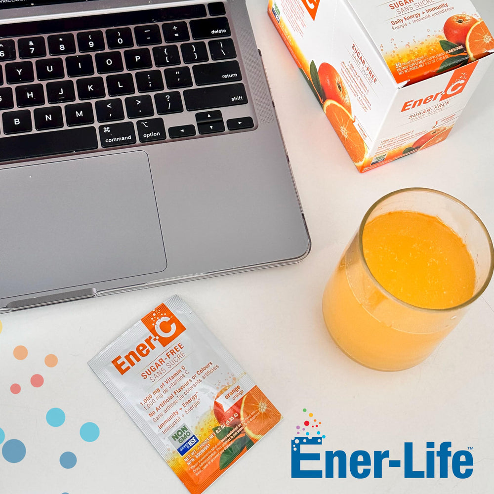 Ready-to-mix Ener-C vitamin drink packets beside a glass of water