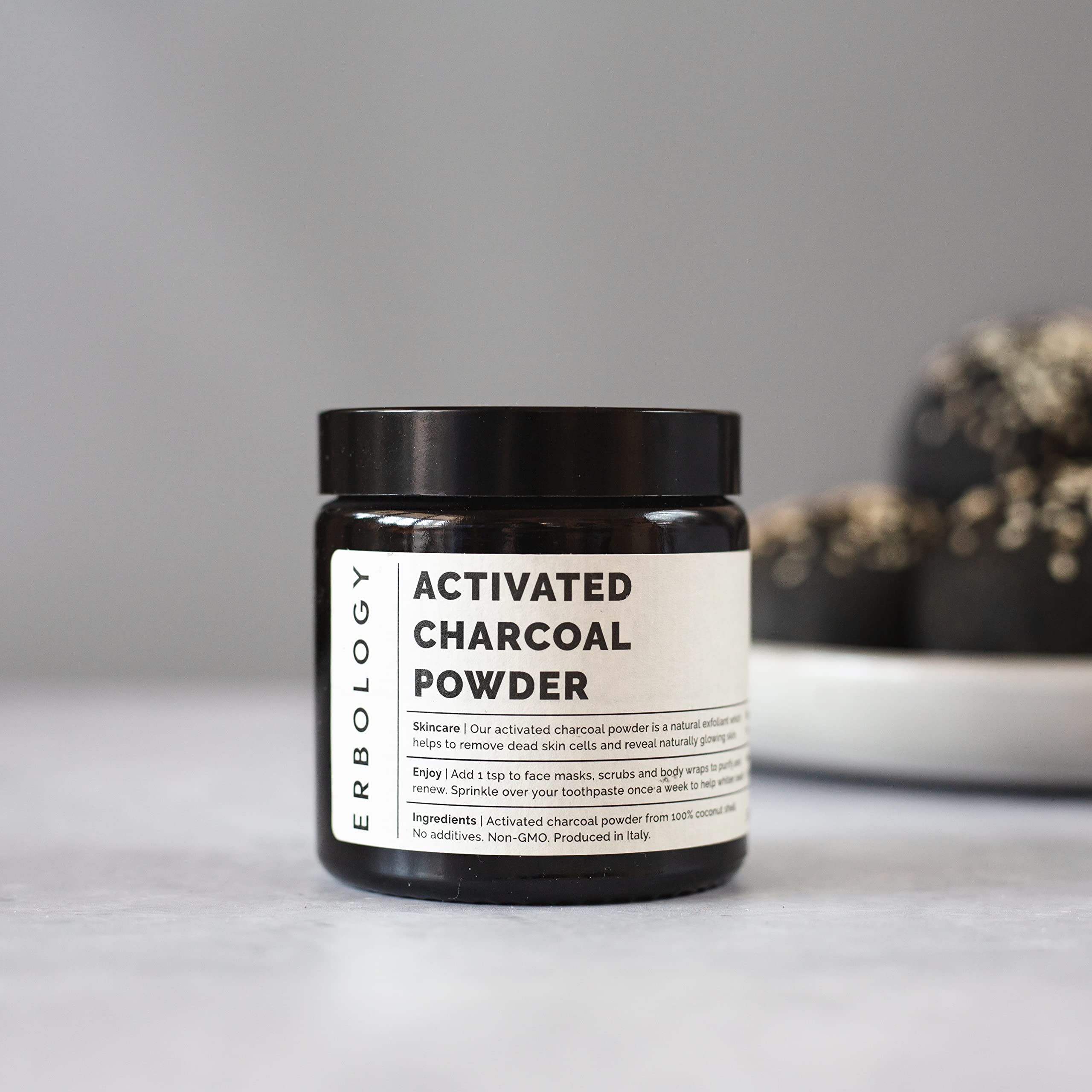 Applying activated charcoal powder in a facial mask