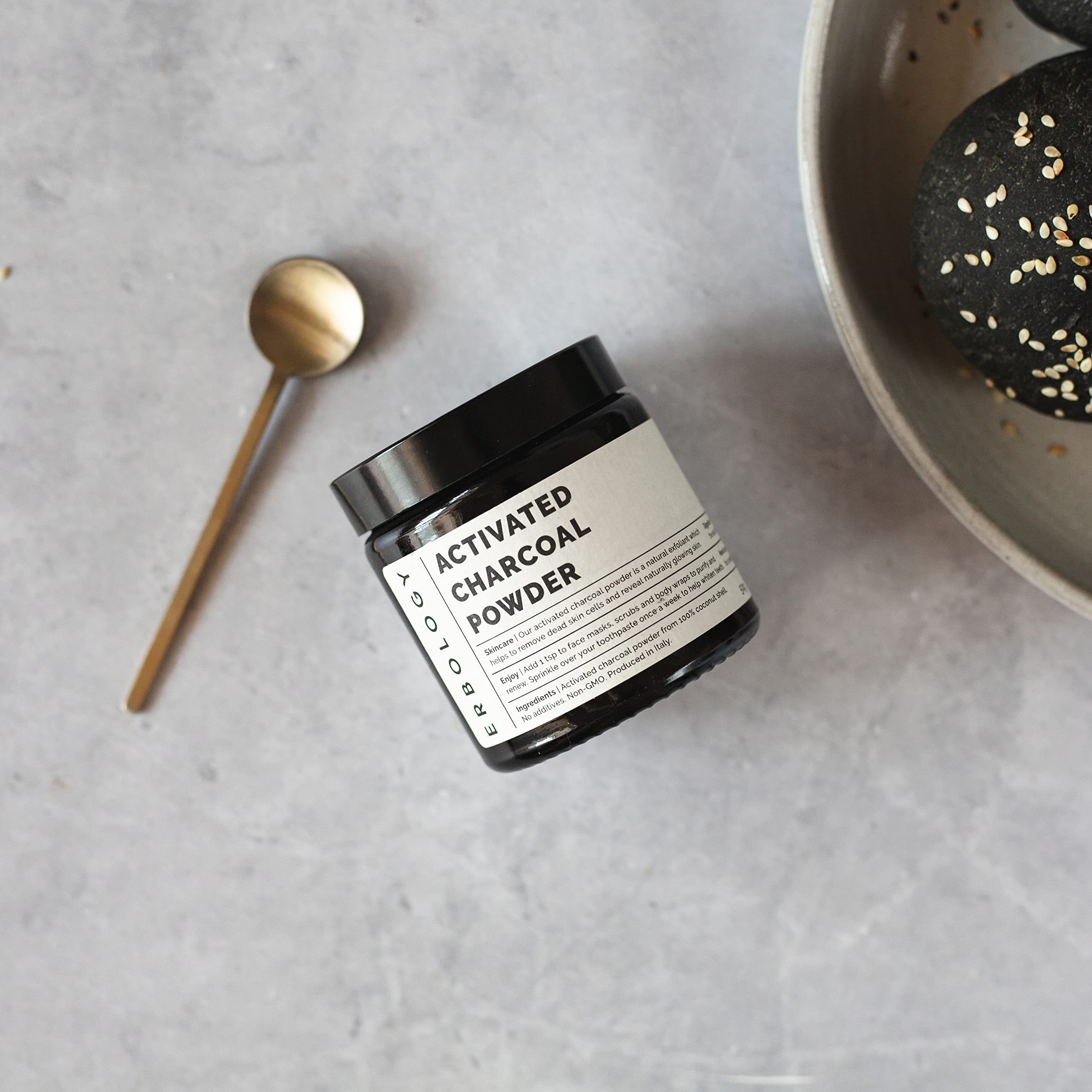 Using activated charcoal powder for teeth whitening on a toothbrush