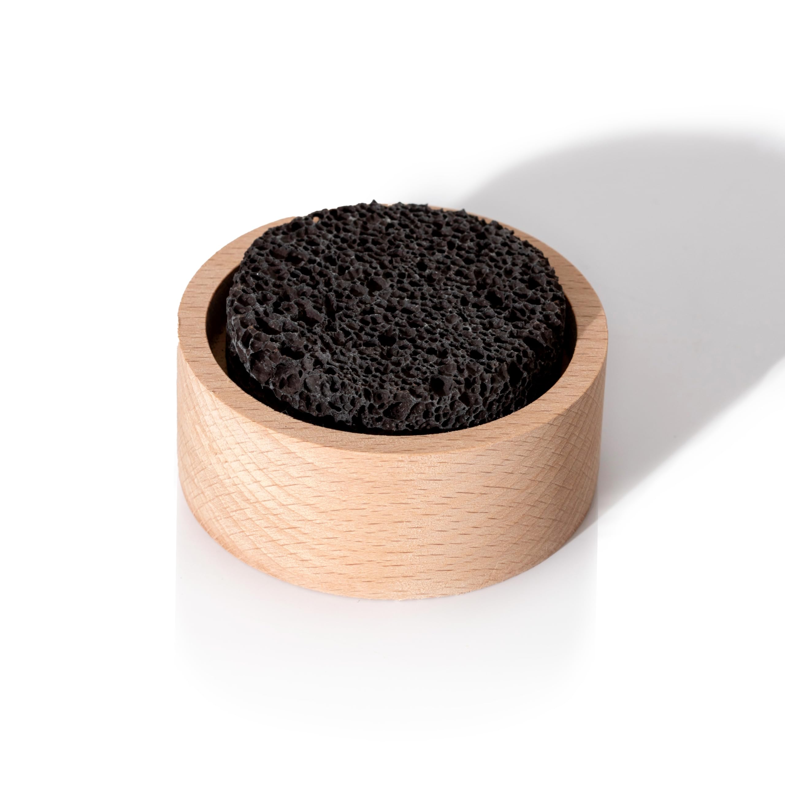 Applying essential oil drops to lava rock diffuser
