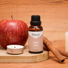 ESSLUX bottle on a cozy kitchen counter with mug, evoking a warm home fragrance benefit