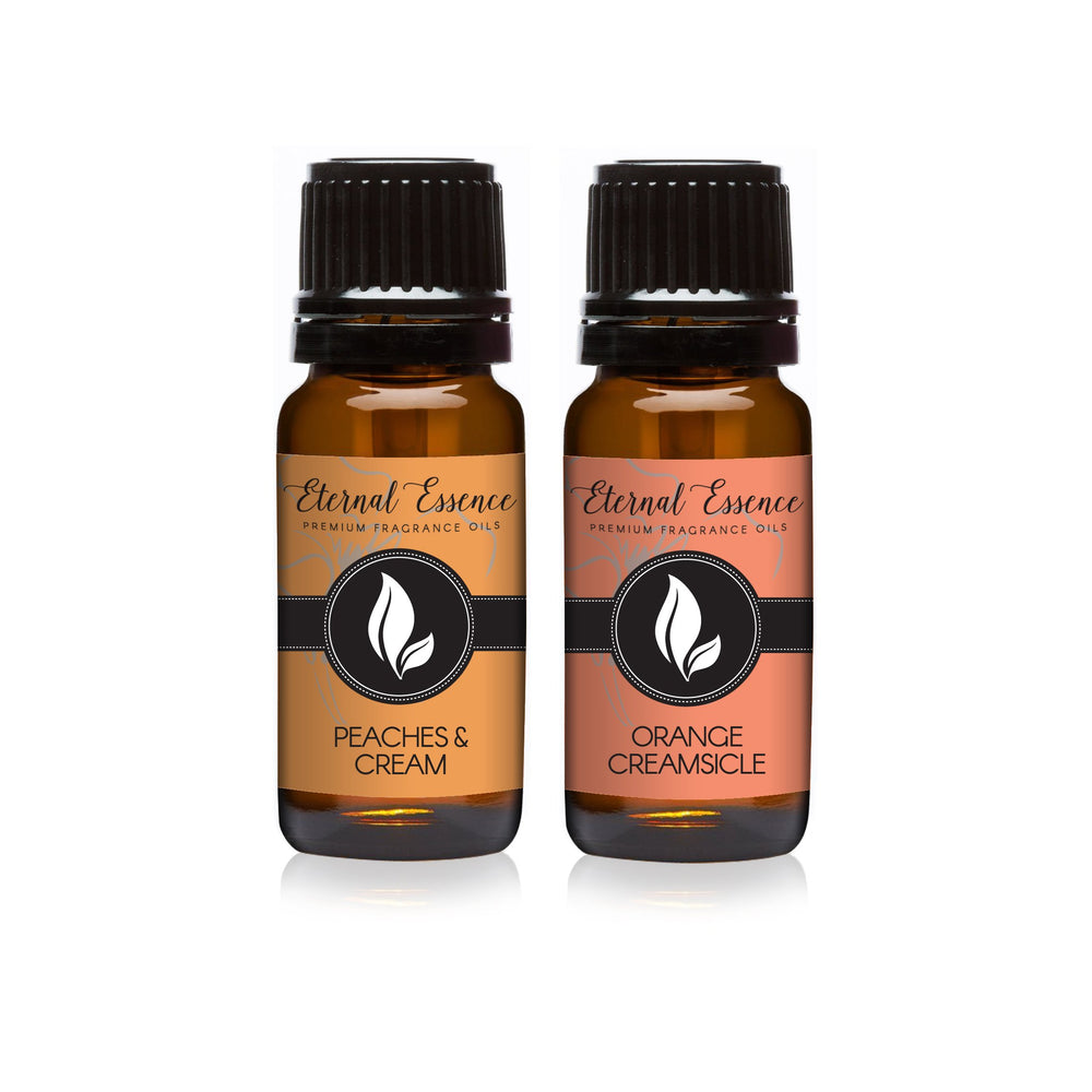 Two 10ml amber glass fragrance oil bottles: Peaches & Cream and Orange Creamsicle