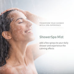 Showerhead releasing aromatherapy mist in a modern bathroom
