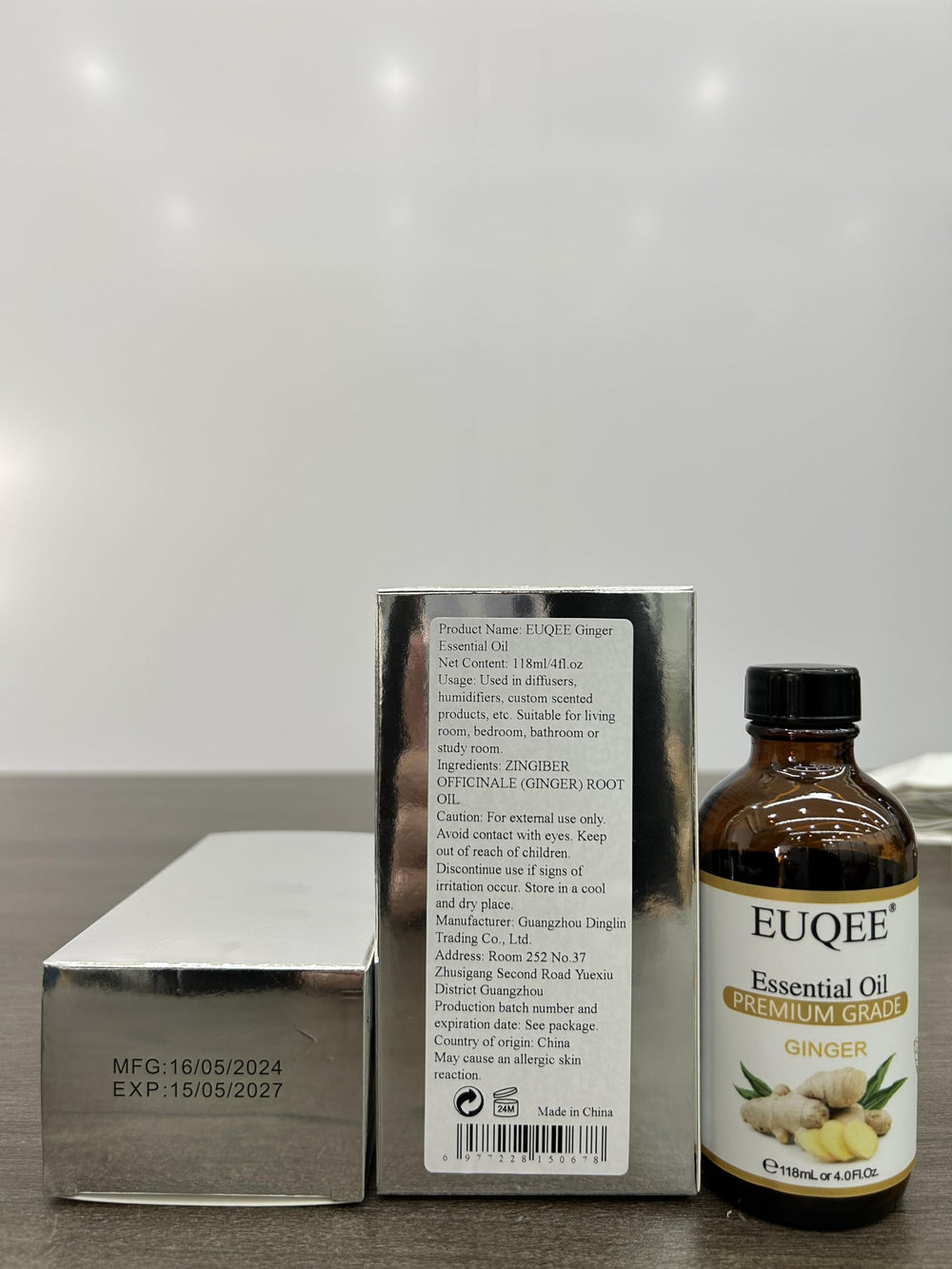 Close-up of glass dropper dispensing ginger essential oil