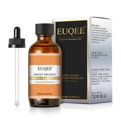 Lifestyle shot of orange fragrance oil and amber glass bottle