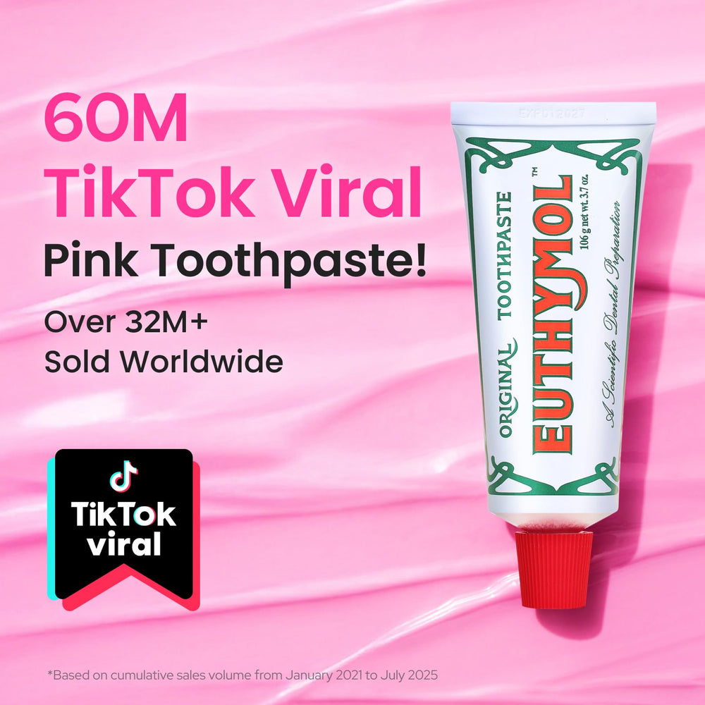Pink toothpaste tube close-up showing branding