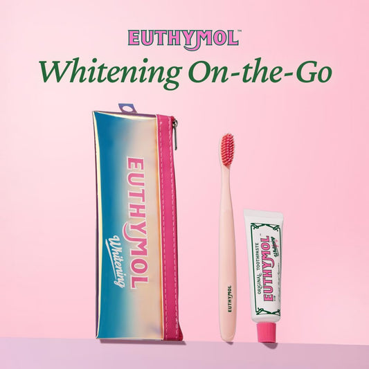 Compact EUTHYMOL travel toothbrush beside toothpaste