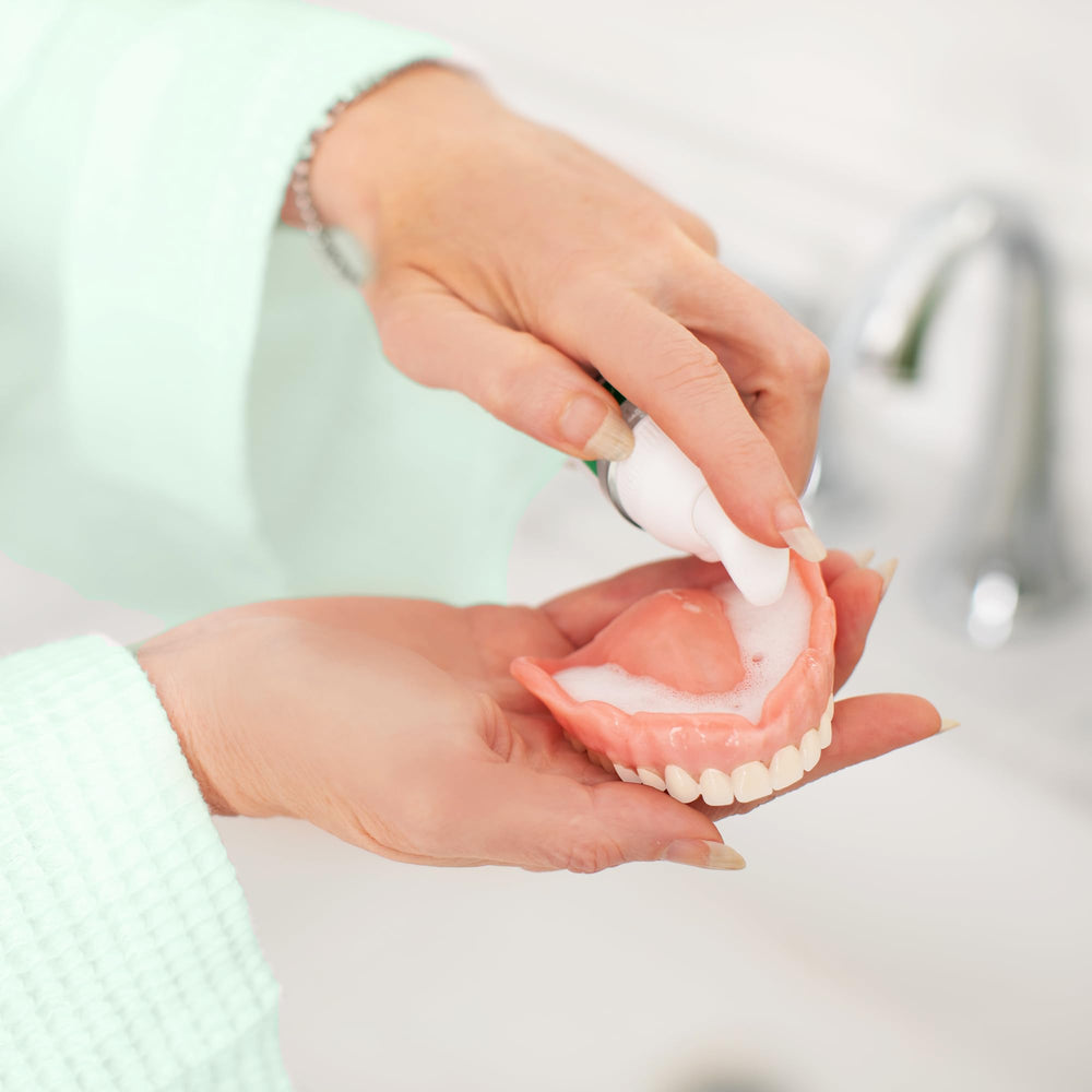 Travel-size 2-piece FreshDent denture cleaner in a compact pack.
