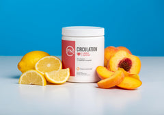 Fenix Nutrition L-Arginine Complete powder scoop next to glass of water for easy mixing