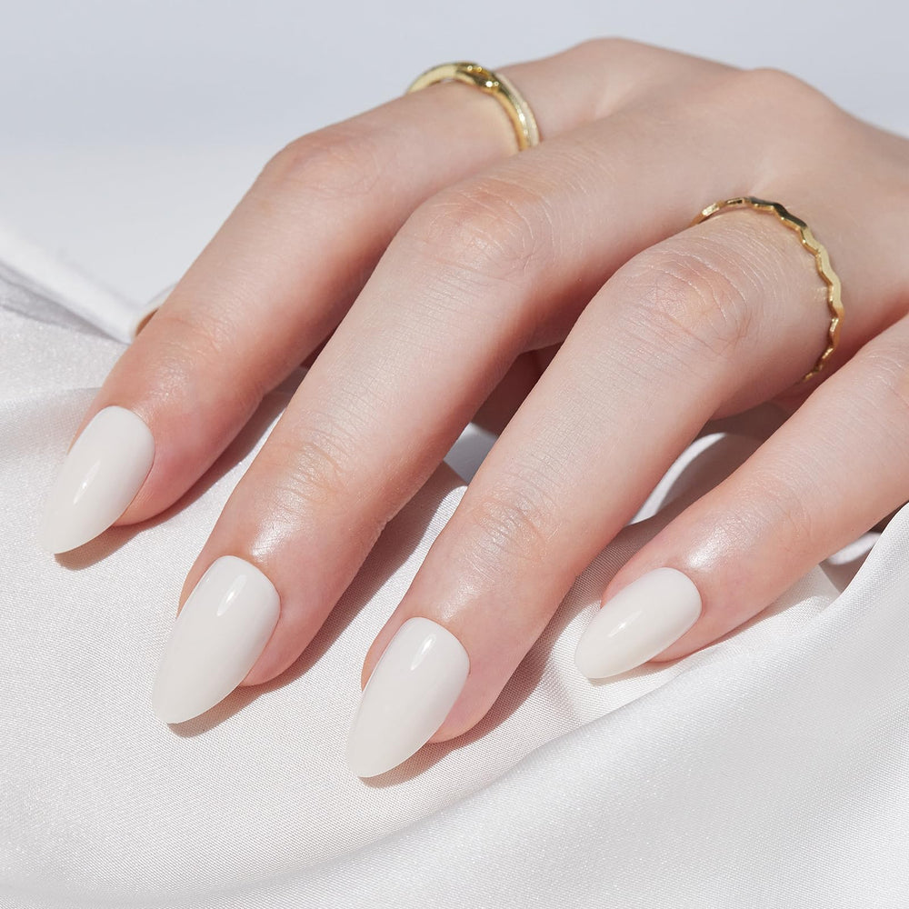 Findigit almond cream white nails on hand showcase a clean, elegant look.