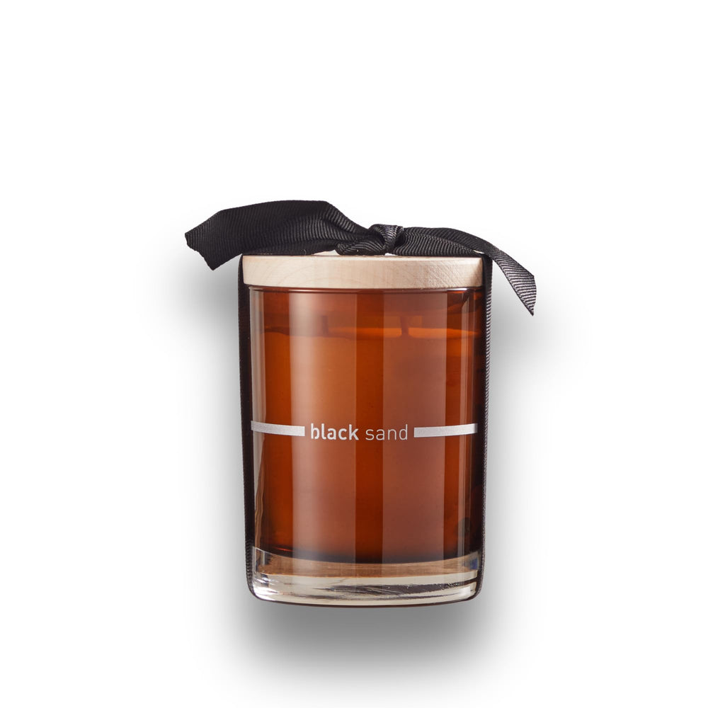 FINN & CO Black Sand candle amber jar closeup highlighting coastal warmth.