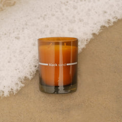 FINN & CO Black Sand candle sandalwood-vanilla scent for room ambiance.