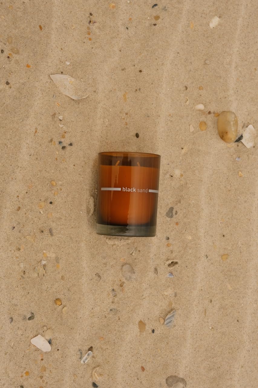 FINN & CO Black Sand candle lit glow for sunset mood.