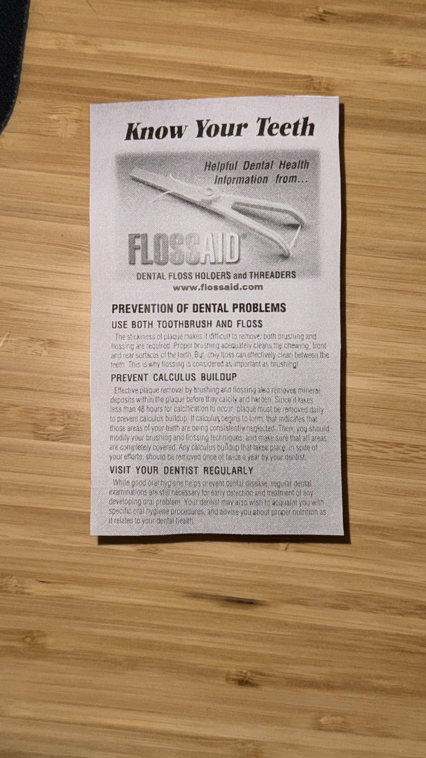 Person using Flossaid dental floss holder