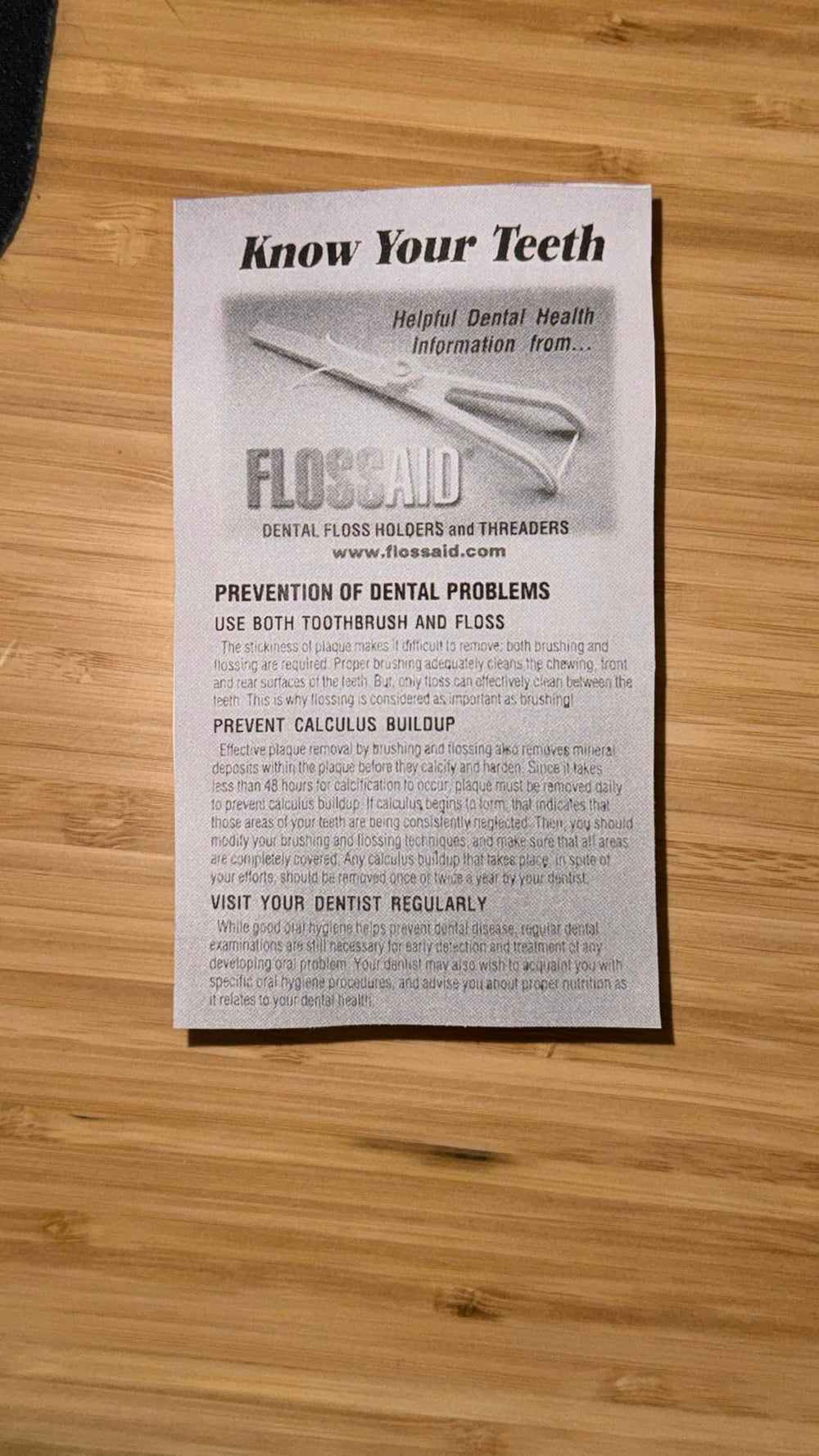 Person using Flossaid dental floss holder