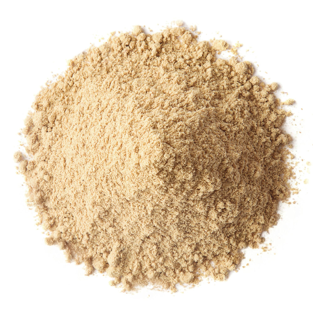 Close-up of red, yellow, and black maca powder
