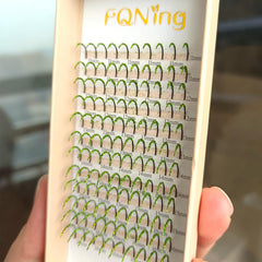 FQNing glitter lash extensions on tray with vibrant light green sparkle for party-ready eyes