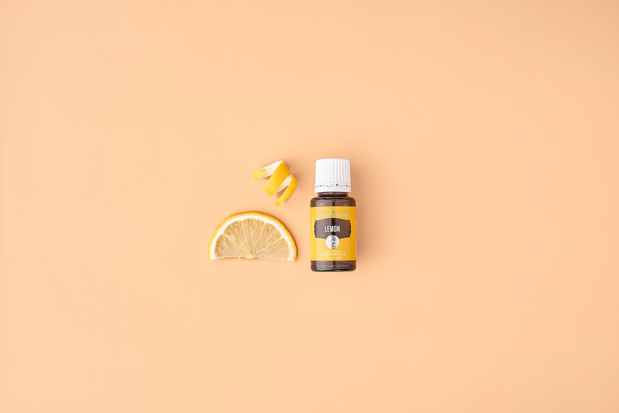 Fresh lemon slices beside lemon oil